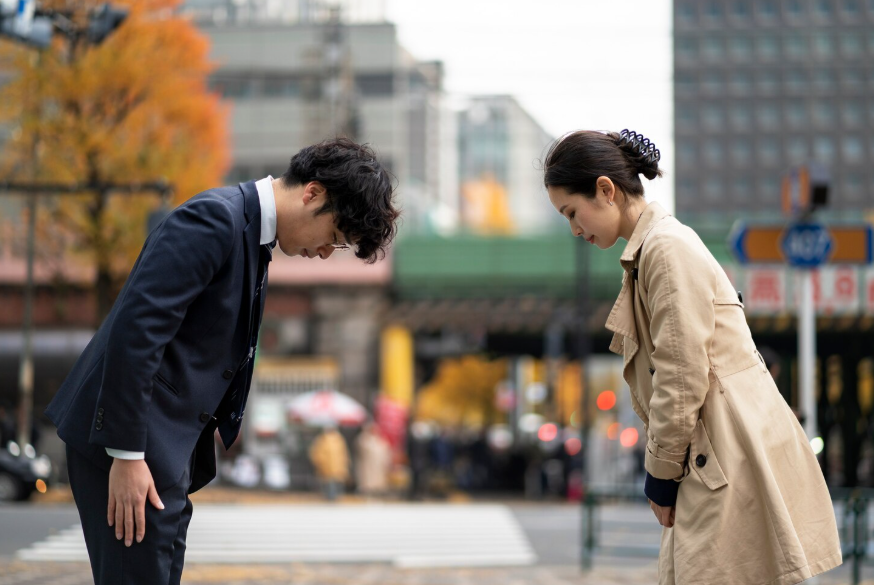 People bowing in public showing how different countries define good manners