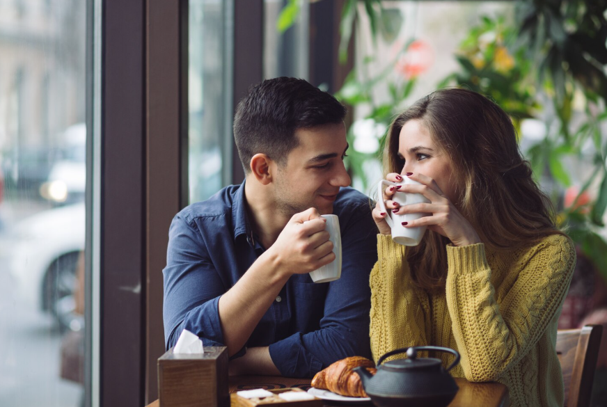 Dating customs around the world shown through a couple sharing coffee on a casual date