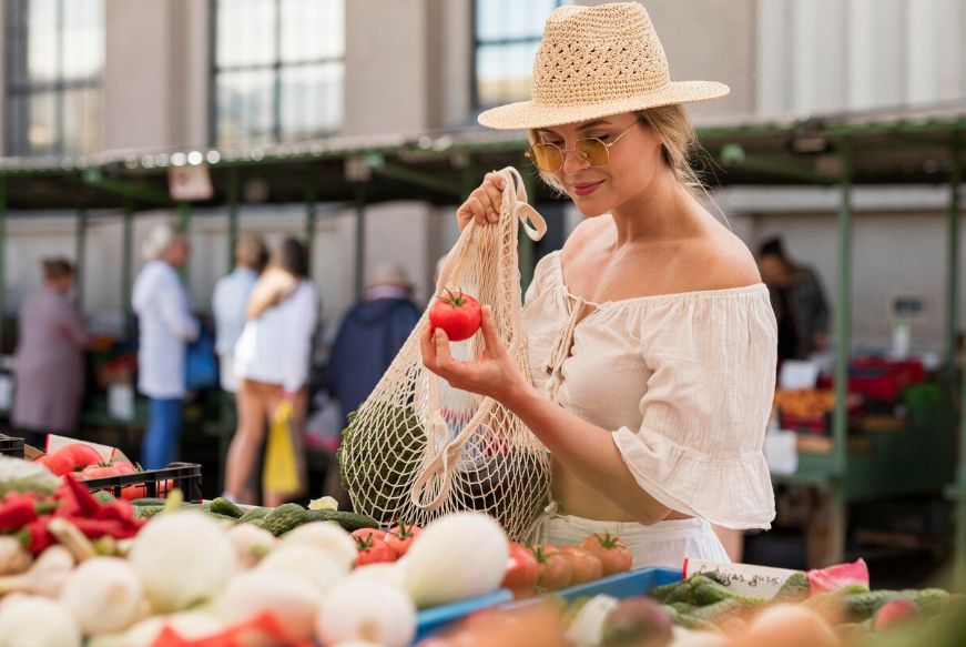 Cheapest countries to live in illustrated by woman shopping for fresh produce at a local market